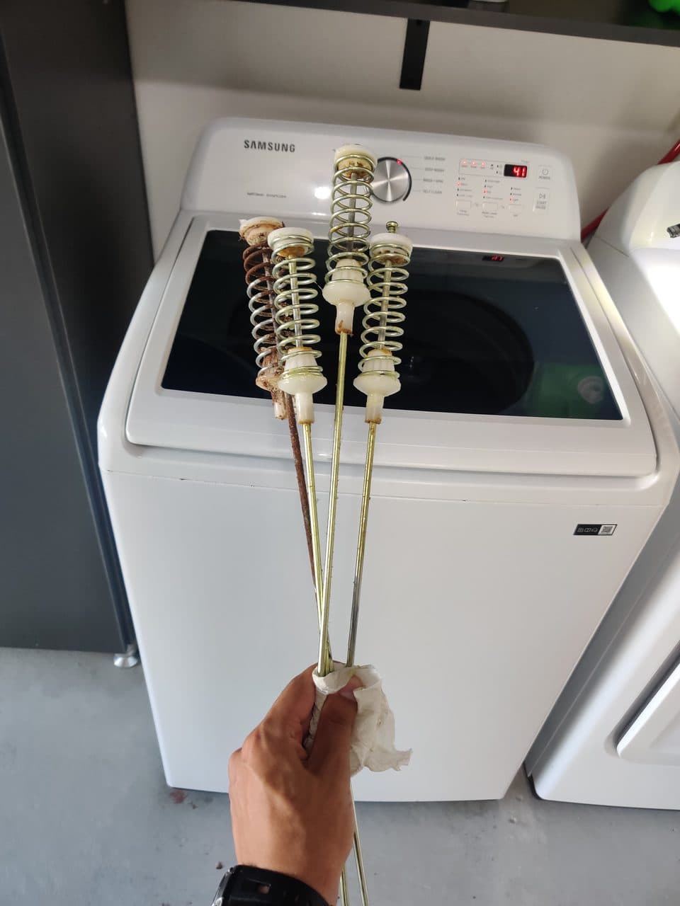 Worn suspension rods removed from the washer: Samsung washer, model WA45T3200AW (washer repair in Palmetto Bay, FL, July 2026)