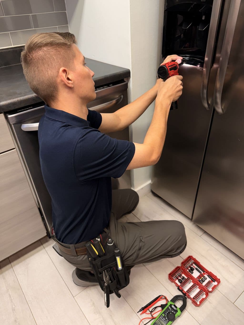 Vladimir repairing a refrigerator