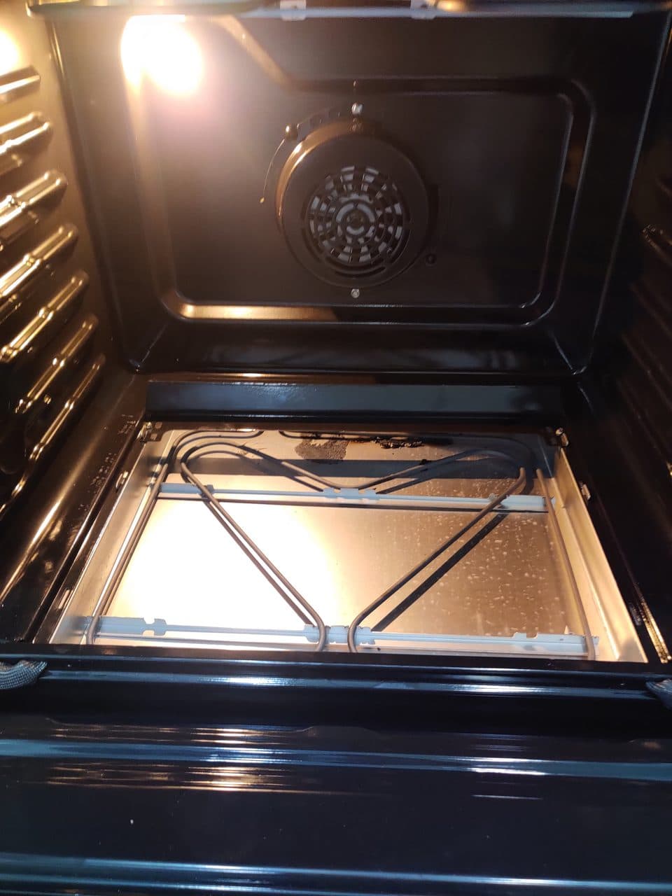 Inside an electric oven: bake element and convection fan
